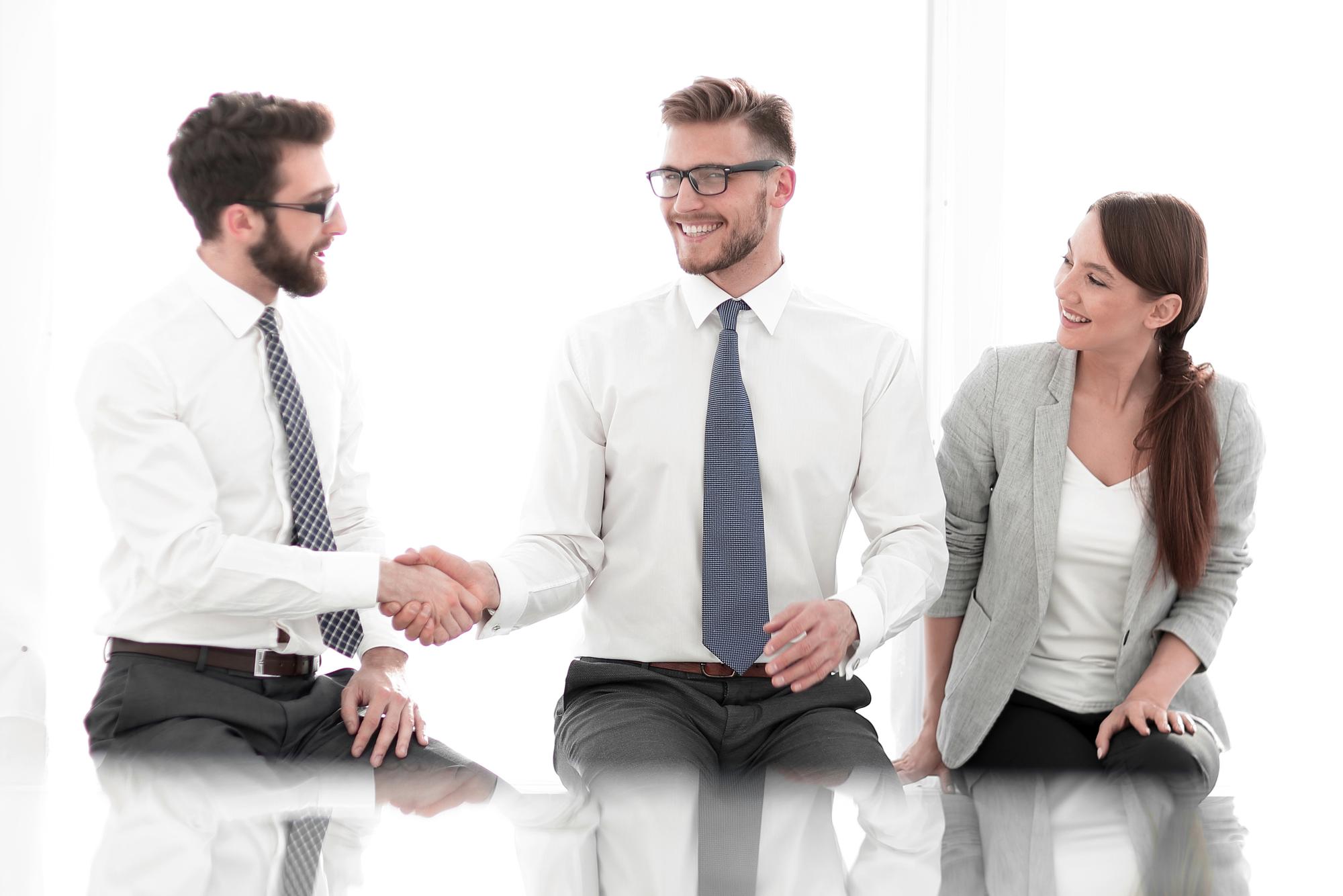 advisor shaking hands with client in premium office